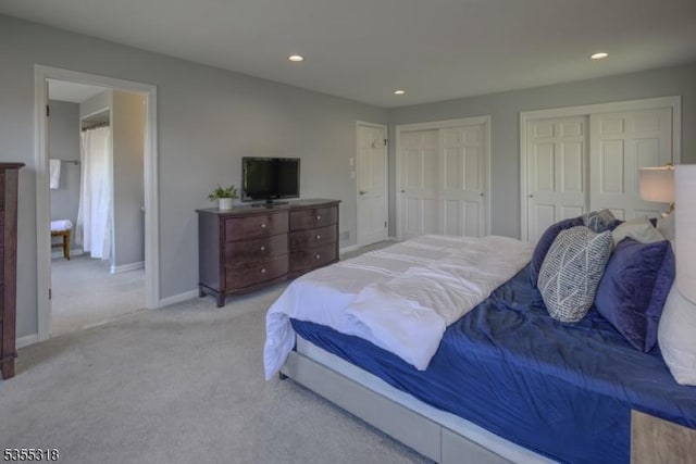 bedroom featuring recessed lighting, baseboards, carpet floors, and two closets