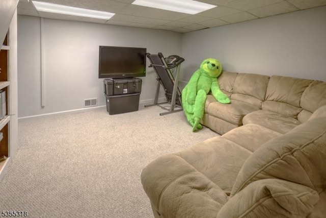 carpeted living room with baseboards, a drop ceiling, and visible vents