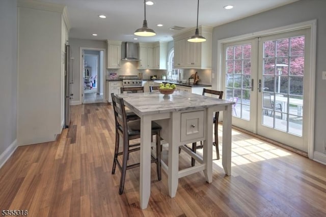 dining room with recessed lighting, baseboards, french doors, and light wood-style floors