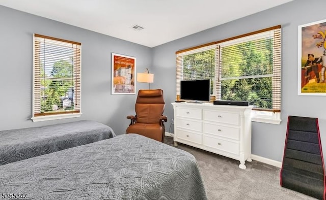bedroom with baseboards, multiple windows, carpet flooring, and visible vents