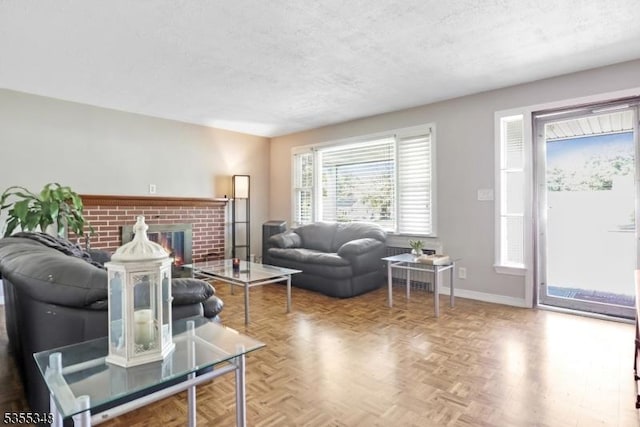 living area featuring a textured ceiling, baseboards, and a fireplace
