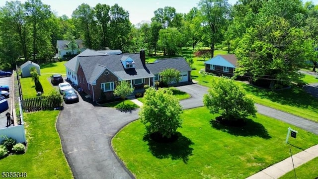 aerial view of property and surrounding area with a tree filled landscape