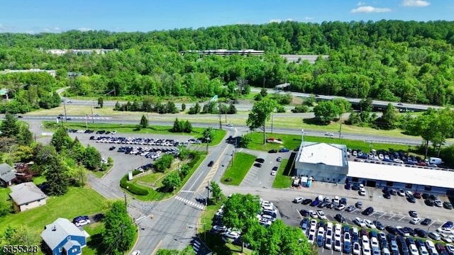 aerial overview of property's location with a heavily wooded area
