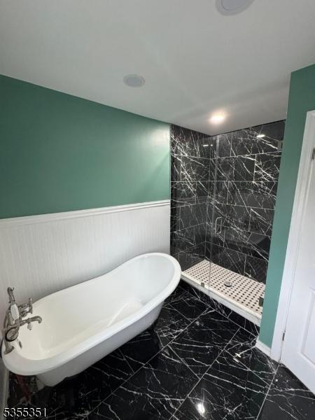 385 Stiles St, Union Twp, NJ 07088 - bathroom with a wainscoted wall, marble finish floors, a freestanding tub, and a tile shower