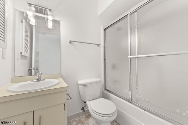 full bathroom featuring toilet, baseboards, vanity, and bath / shower combo with glass door