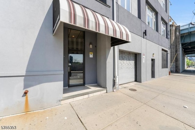 entrance to property with stucco siding