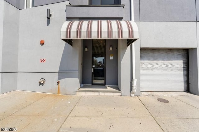 entrance to property with stucco siding