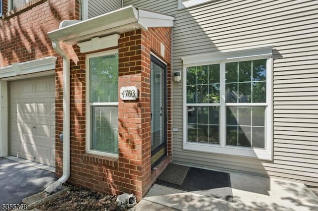 4703 Patterson St, Bridgewater Twp, NJ 08807 - view of side of home with an attached garage and brick siding