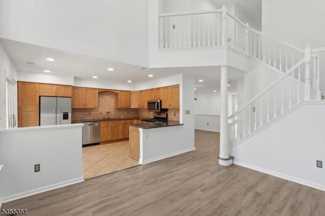 4703 Patterson St, Bridgewater Twp, NJ 08807 - kitchen featuring appliances with stainless steel finishes, a sink, light wood-type flooring, decorative columns, and recessed lighting