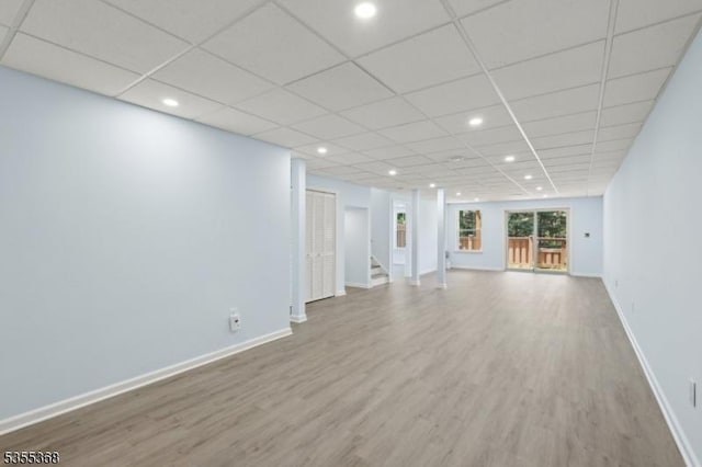 4703 Patterson St, Bridgewater Twp, NJ 08807 - unfurnished living room featuring wood finished floors, baseboards, stairs, recessed lighting, and a paneled ceiling