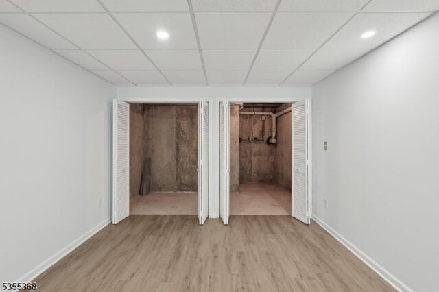 4703 Patterson St, Bridgewater Twp, NJ 08807 - unfurnished bedroom with light wood-style floors, baseboards, recessed lighting, ensuite bathroom, and a drop ceiling