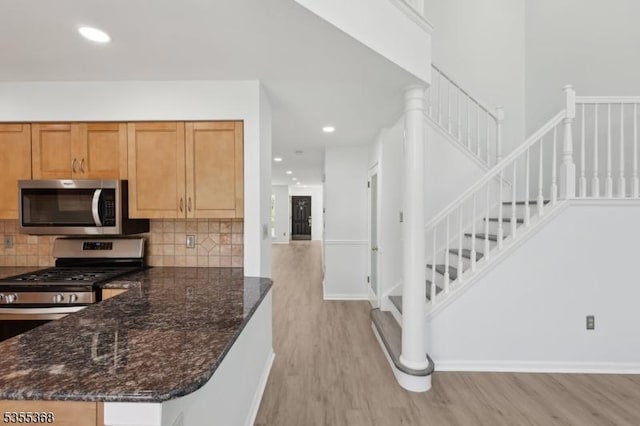 4703 Patterson St, Bridgewater Twp, NJ 08807 - kitchen featuring stainless steel appliances, light wood-style flooring, decorative backsplash, dark stone counters, and recessed lighting