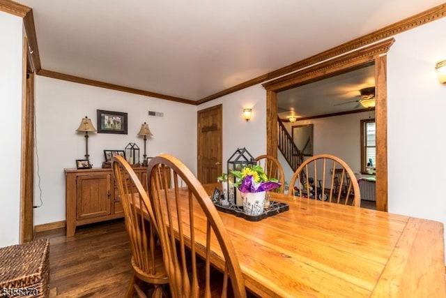 dining area with crown molding, stairs, dark wood-type flooring, and ceiling fan