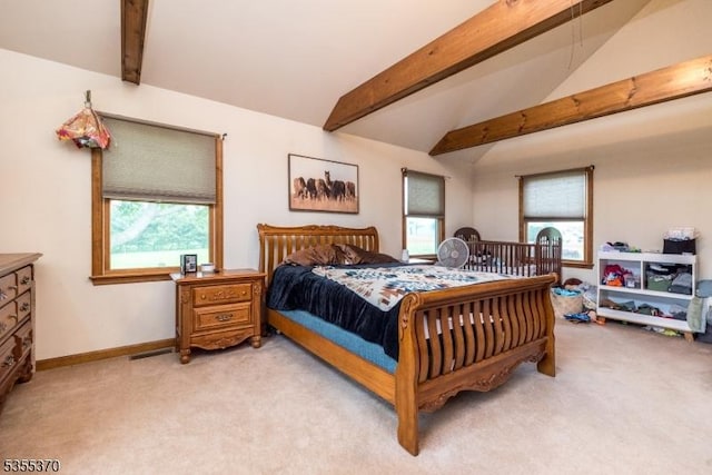 bedroom with light colored carpet and baseboards