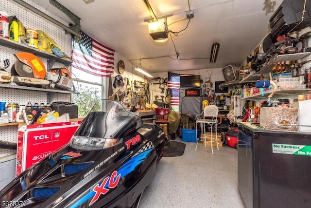 garage featuring a garage door opener and a workshop area