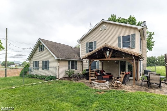 rear view of property featuring a fire pit, a patio, and a chimney