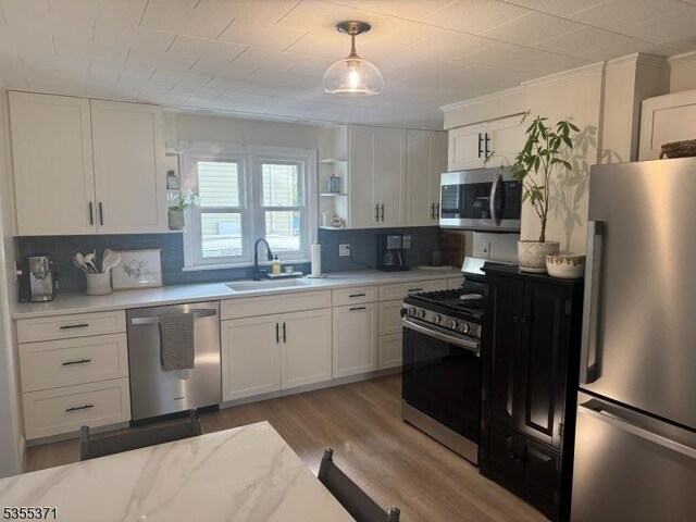 11 Union St, Franklin Twp, NJ 08528 - kitchen featuring appliances with stainless steel finishes, a sink, light countertops, and white cabinets