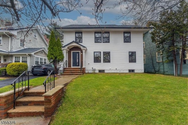 view of front of home with crawl space and a front lawn
