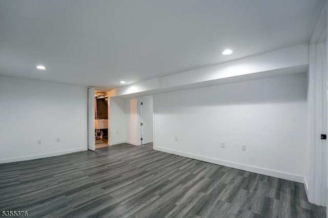 finished below grade area featuring recessed lighting, baseboards, and dark wood-style floors