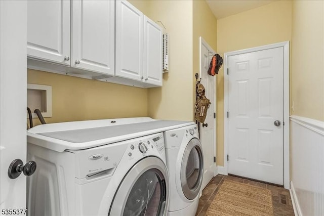 washroom with cabinet space and washer and dryer