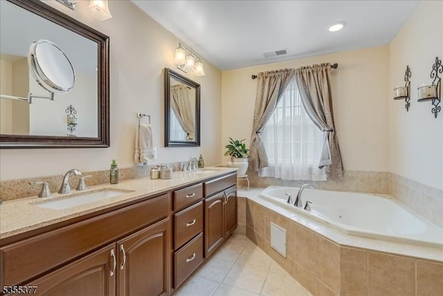 bathroom with tile patterned flooring, a bath, and double vanity