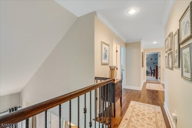 hall with dark wood-style floors, an upstairs landing, recessed lighting, crown molding, and baseboards