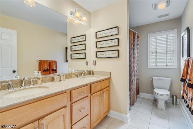 full bathroom with toilet, baseboards, double vanity, and tile patterned flooring