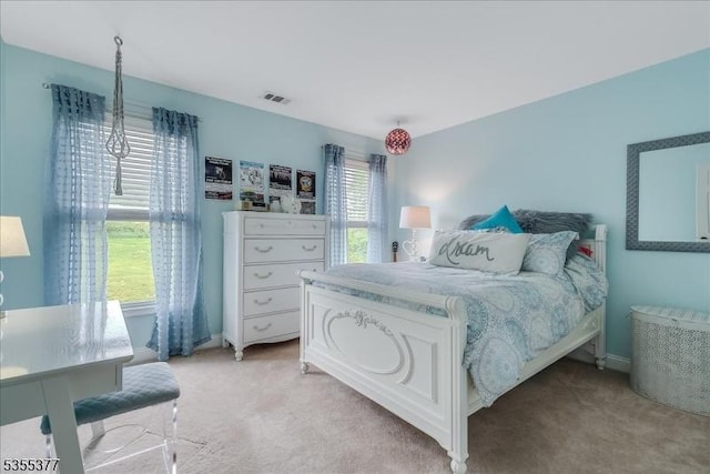bedroom featuring light colored carpet and baseboards