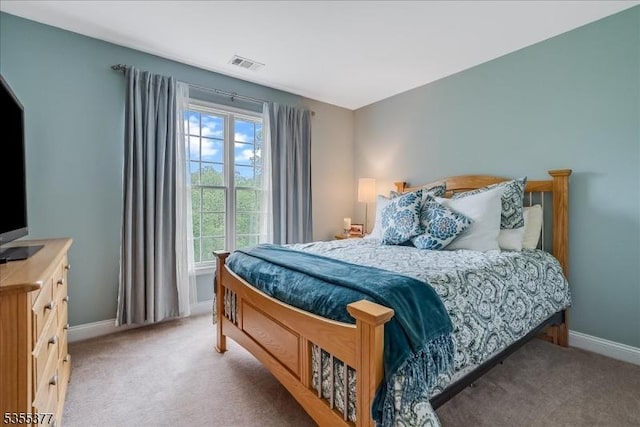 bedroom featuring light carpet and baseboards