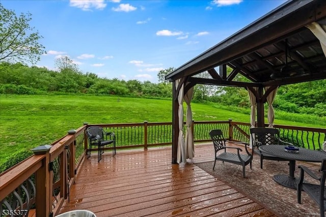deck featuring a gazebo and a yard