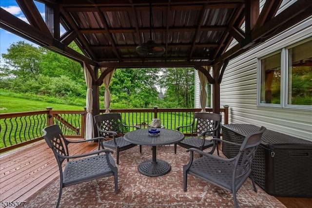 wooden terrace with a lawn