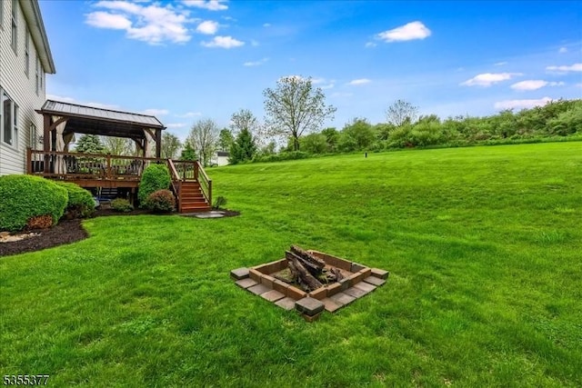 view of grassy yard with a deck and stairs