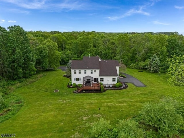view from above of property featuring a heavily wooded area