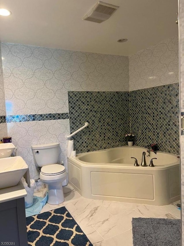 3 Harbor Front Ct Unit 3, Elizabeth City, NJ 07206 - full bath featuring toilet, a bath, vanity, marble finish flooring, and tile walls