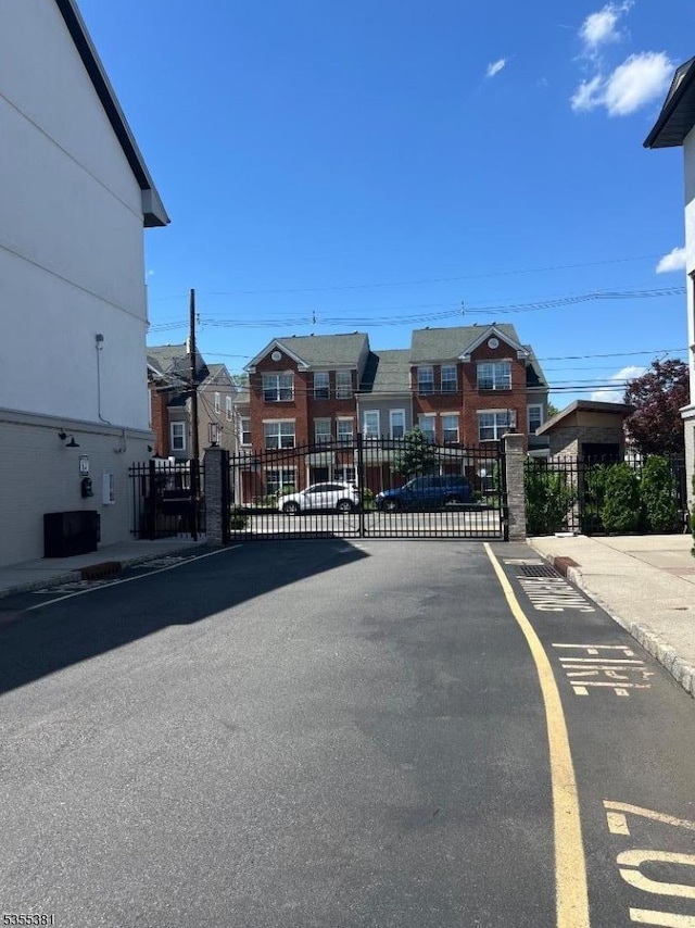3 Harbor Front Ct Unit 3, Elizabeth City, NJ 07206 - view of asphalt street with a gate, curbs, sidewalks, a residential view, and a gated entry