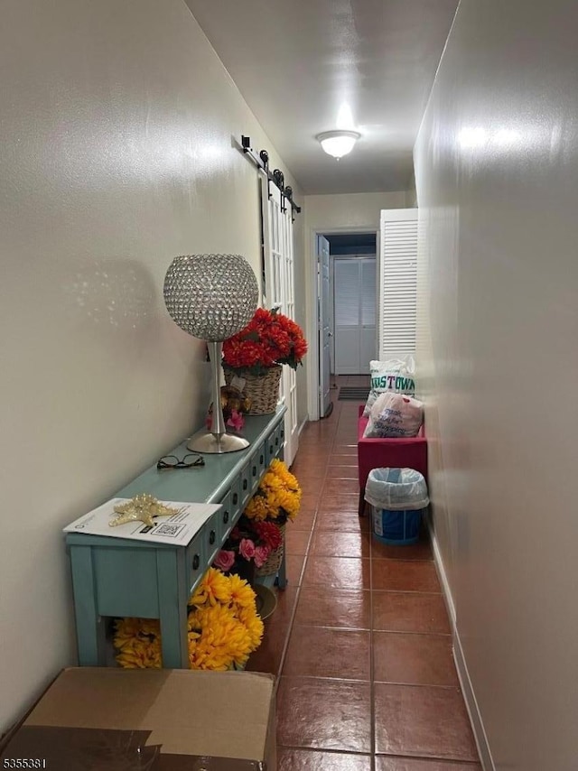 3 Harbor Front Ct Unit 3, Elizabeth City, NJ 07206 - hallway with a barn door, baseboards, and tile patterned flooring