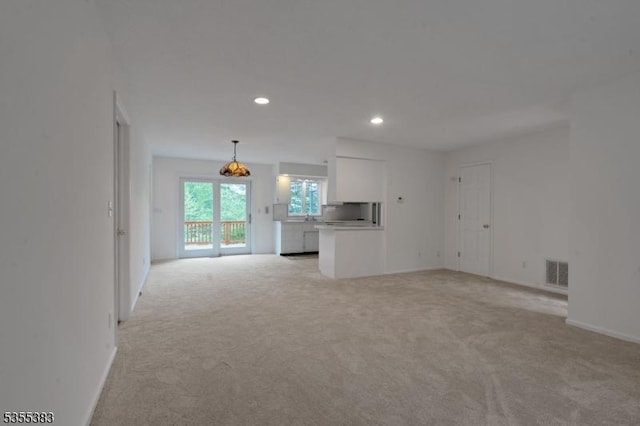 31 Charlotte Dr, Clinton Twp, NJ 08833 - unfurnished living room featuring light colored carpet, recessed lighting, and baseboards