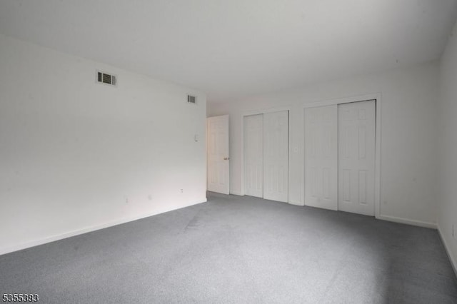 31 Charlotte Dr, Clinton Twp, NJ 08833 - unfurnished bedroom featuring two closets, carpet, and baseboards