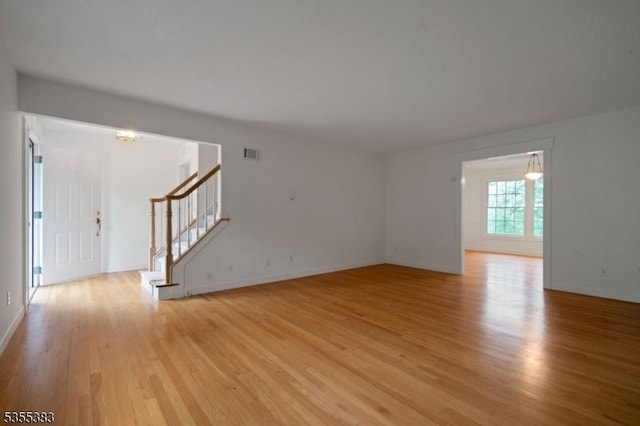31 Charlotte Dr, Clinton Twp, NJ 08833 - unfurnished living room with stairway, light wood finished floors, and baseboards