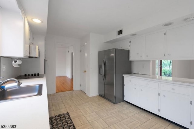 31 Charlotte Dr, Clinton Twp, NJ 08833 - kitchen with a sink, stainless steel fridge, light countertops, white cabinets, and recessed lighting