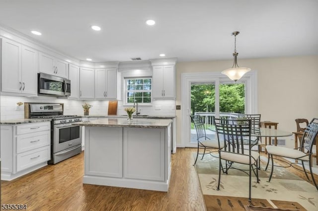 95 School House Rd, Jefferson Twp, NJ 07438 - kitchen featuring appliances with stainless steel finishes, white cabinets, a sink, light wood-style flooring, and light stone counters