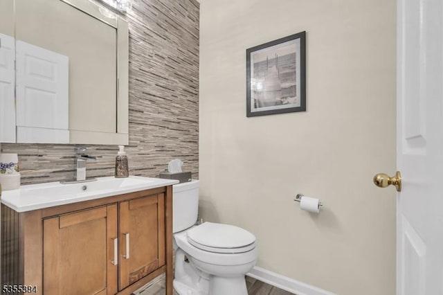 95 School House Rd, Jefferson Twp, NJ 07438 - half bathroom featuring toilet, tasteful backsplash, vanity, baseboards, and wood finished floors