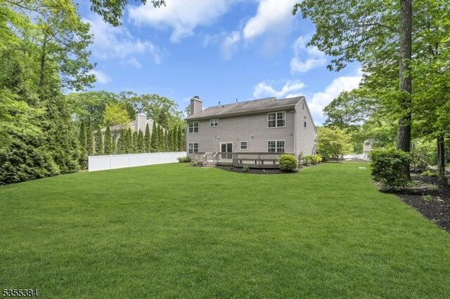 95 School House Rd, Jefferson Twp, NJ 07438 - rear view of house with a deck and a chimney