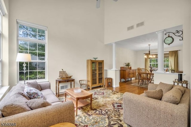 95 School House Rd, Jefferson Twp, NJ 07438 - living room with a towering ceiling, decorative columns, plenty of natural light, and a chandelier