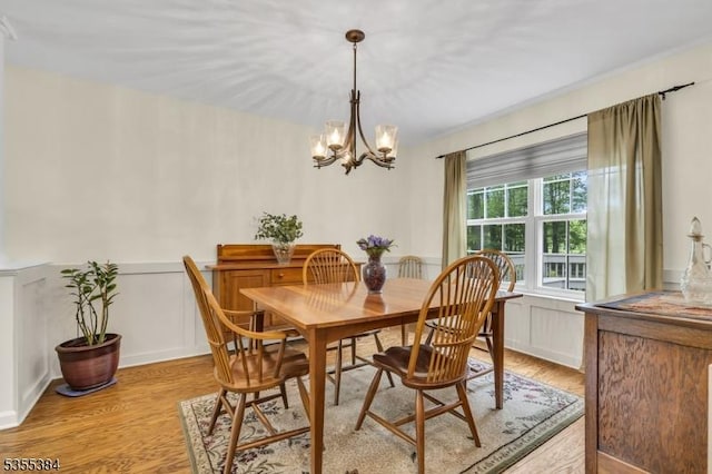 95 School House Rd, Jefferson Twp, NJ 07438 - dining area featuring light wood-type flooring, a chandelier, a wainscoted wall, and a decorative wall