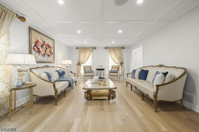 living room featuring visible vents, light wood-type flooring, beam ceiling, coffered ceiling, and recessed lighting