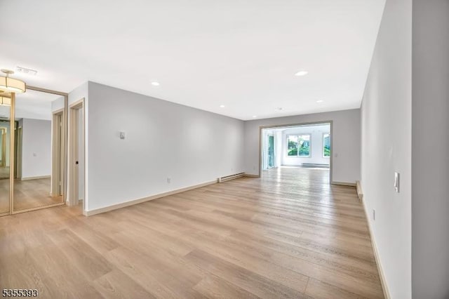 42B Catalpa Plz Unit B, Monroe Twp, NJ 08831 - empty room with light wood finished floors, baseboards, a baseboard heating unit, and recessed lighting