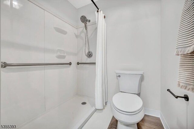 42B Catalpa Plz Unit B, Monroe Twp, NJ 08831 - bathroom with a stall shower, toilet, baseboards, and wood finished floors