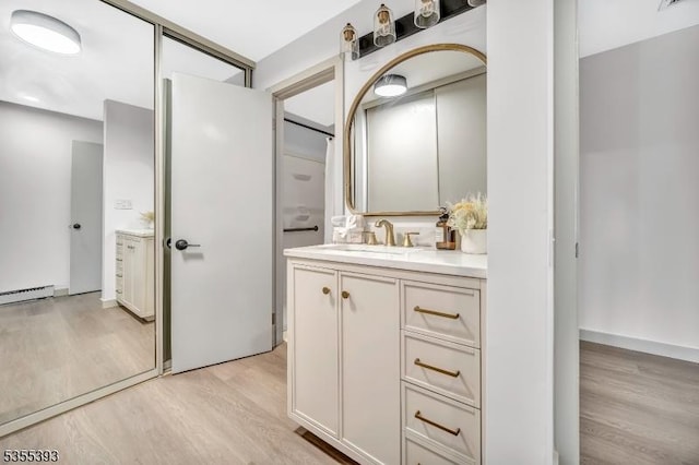 42B Catalpa Plz Unit B, Monroe Twp, NJ 08831 - bathroom with wood finished floors, vanity, and a baseboard heating unit