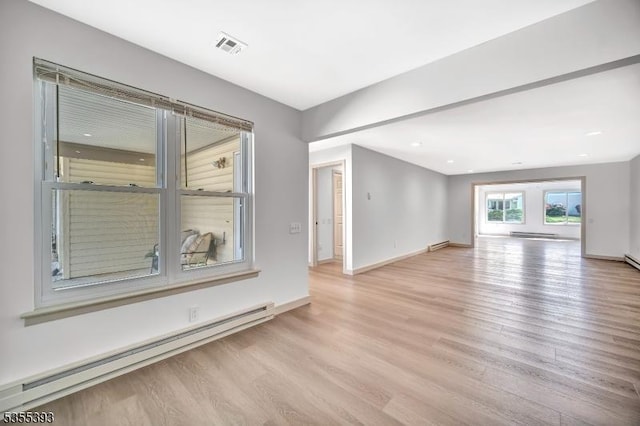 42B Catalpa Plz Unit B, Monroe Twp, NJ 08831 - unfurnished living room with baseboard heating, light wood-style floors, baseboards, a baseboard heating unit, and recessed lighting